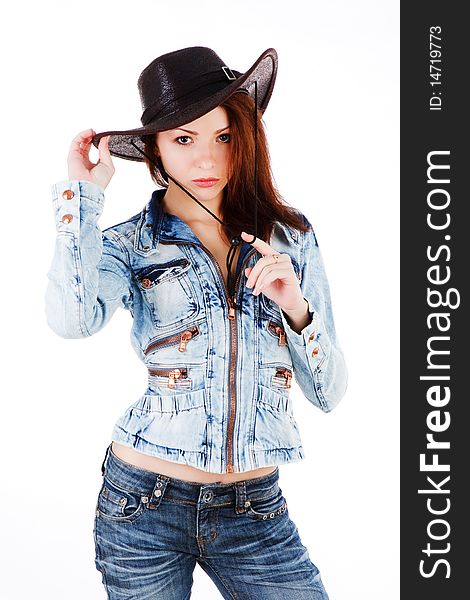 Picture of a young beautiful cowgirl in denim jacket on white background