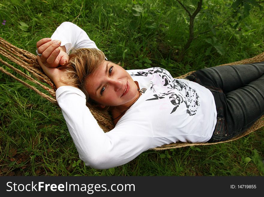 The woman enjoys laying in a hammock. The woman enjoys laying in a hammock