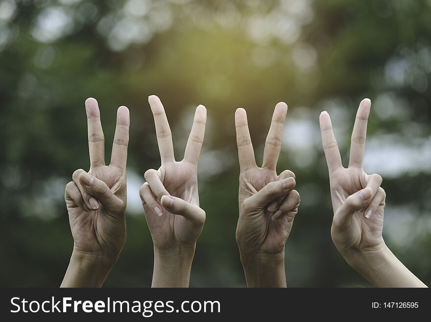 Hand making two finger for victory in nature background