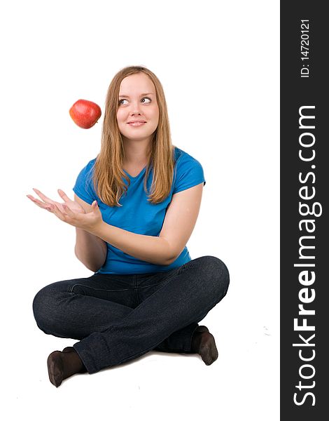 Beautiful girl throws up a red apple, isolated on white. Beautiful girl throws up a red apple, isolated on white