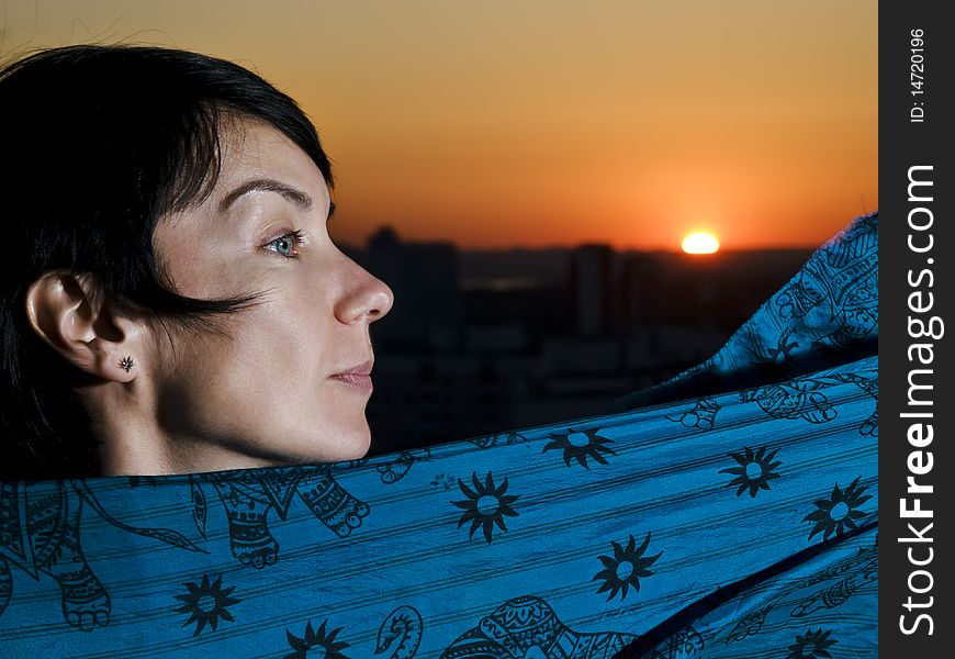 Woman in profile view against a sunset. Woman in profile view against a sunset