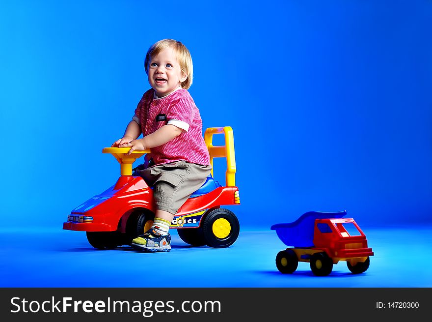 The portrait of a little boy playing with toy cars. The portrait of a little boy playing with toy cars