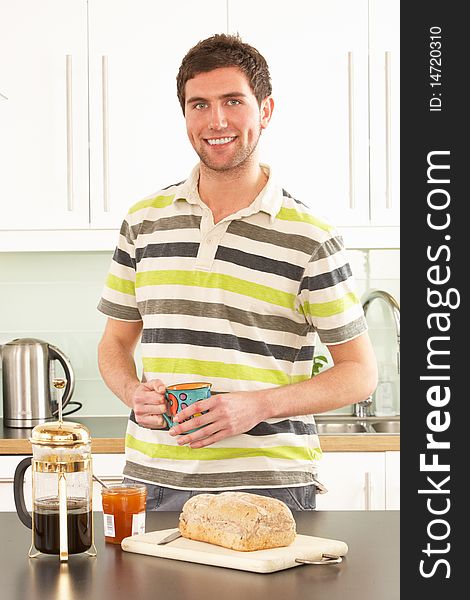 Young Man Preparing Breakfast In Kitchen