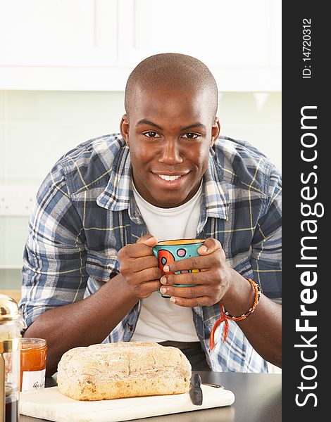 Young Man Preparing Breakfast In Kitchen