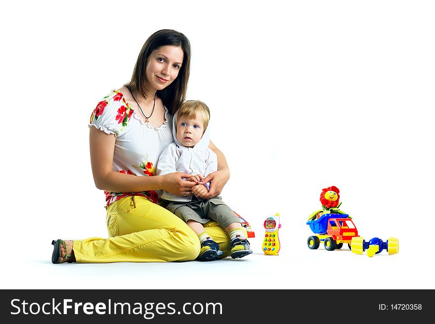 The portrait of a little boy and his mother playing with toys