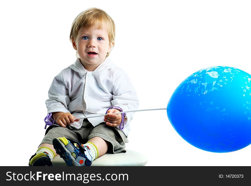 The portrait of a curious little boy holding a big blue balloon