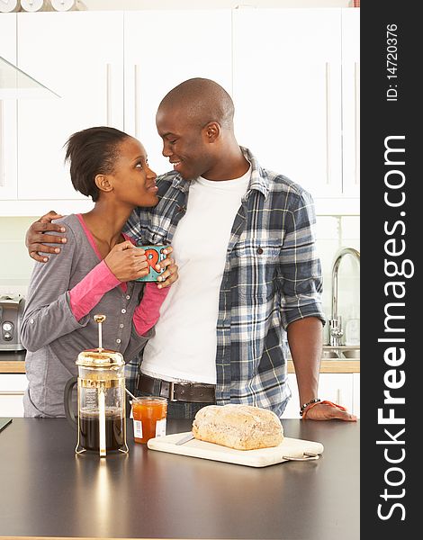 Young Couple Preparing Breakfast In Modern Kitchen