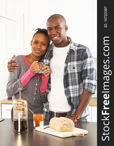 Young Couple Preparing Breakfast In Modern Kitchen