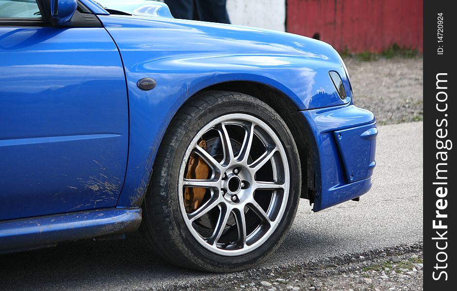 Blue sport car detail on a race track