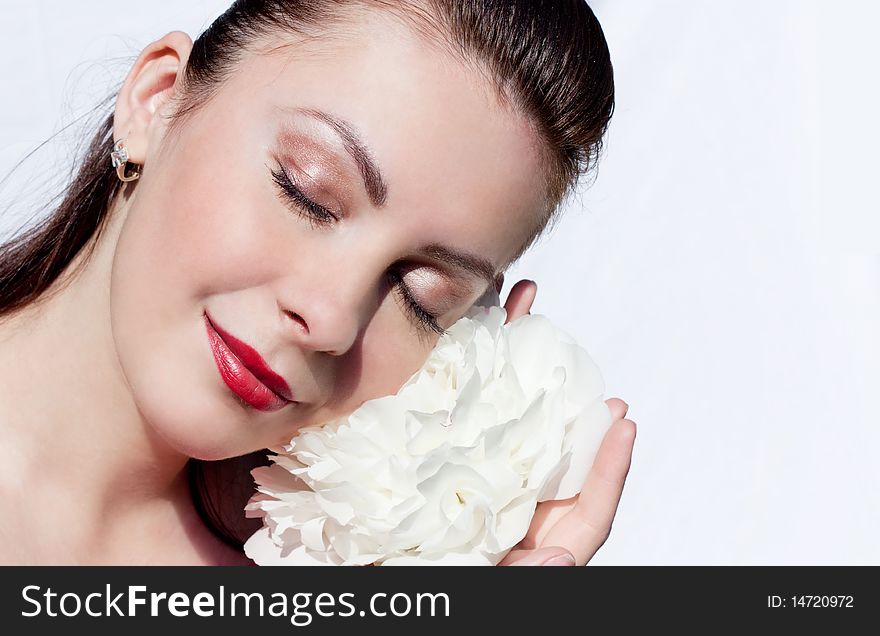 Beautiful woman holding a big white flower. Beautiful woman holding a big white flower