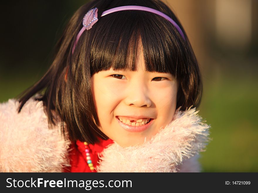 The little Chinese girl smiling in autumn. The little Chinese girl smiling in autumn