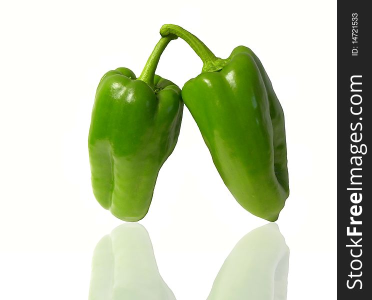 Two green peppers isolated on white background