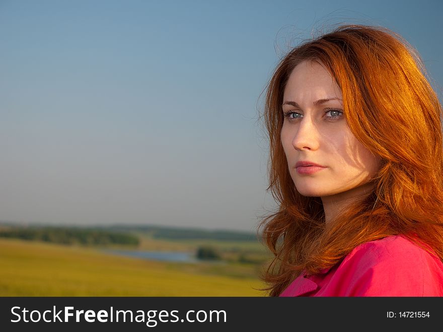 Redhead woman portrait at wheat field sunset
