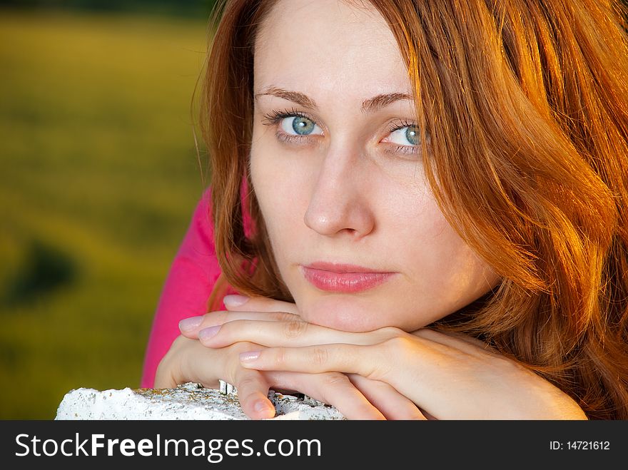 Redhead woman portrait at countryside sunset