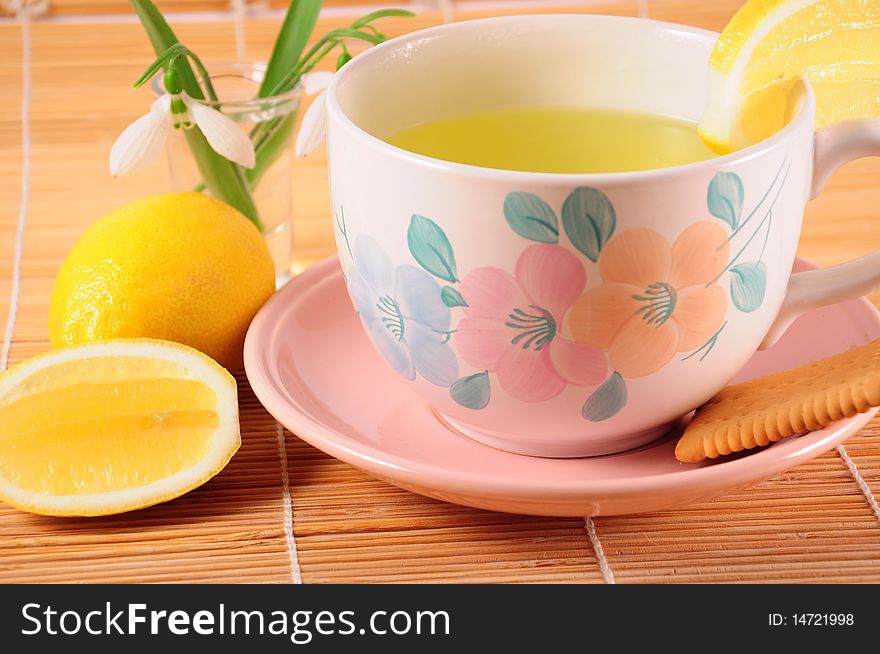 Cup of tea with lemon and biscuit