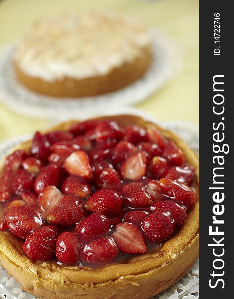 Strawberry cheesecake and fruit cake with meringue at the background.