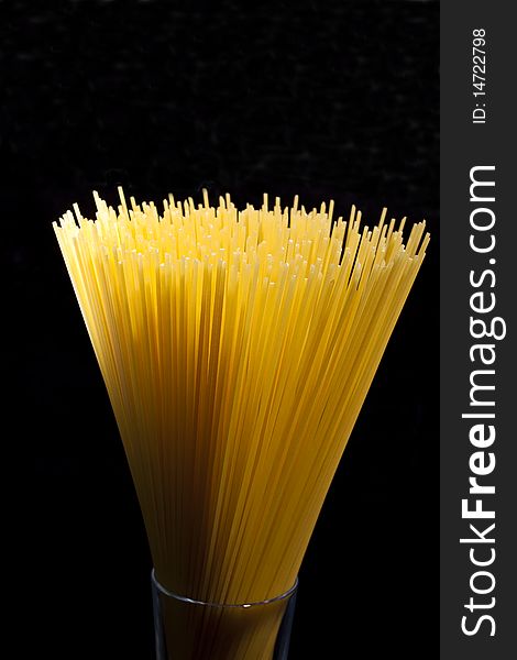 Spaghetti in a glass abstrack light in black background