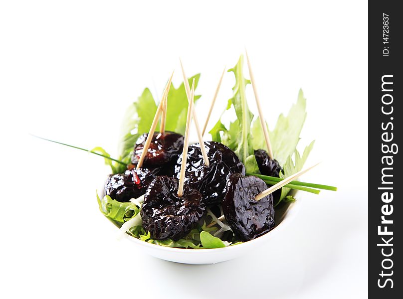 Bowl of greens and glazed prunes - studio. Bowl of greens and glazed prunes - studio