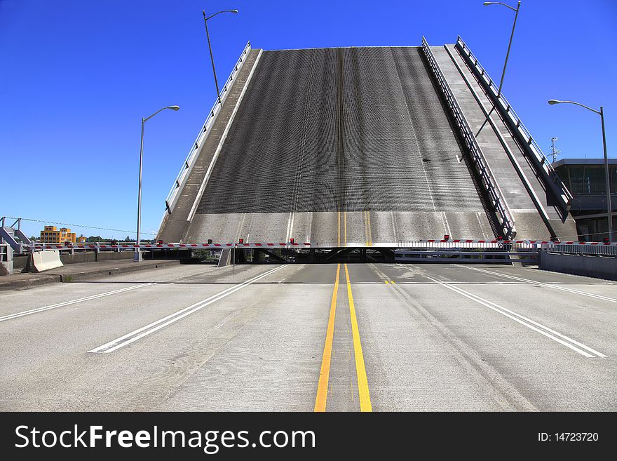 Bridge is raised for a passing push boat and its freight. Bridge is raised for a passing push boat and its freight.