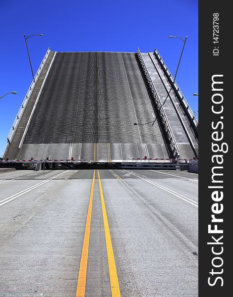 Bridge is raised for a passing push boat and its freight. Bridge is raised for a passing push boat and its freight.