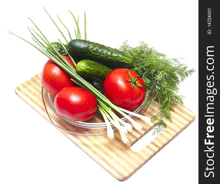 Cucumber, tomatoes and greens, close up on wooden board. Cucumber, tomatoes and greens, close up on wooden board