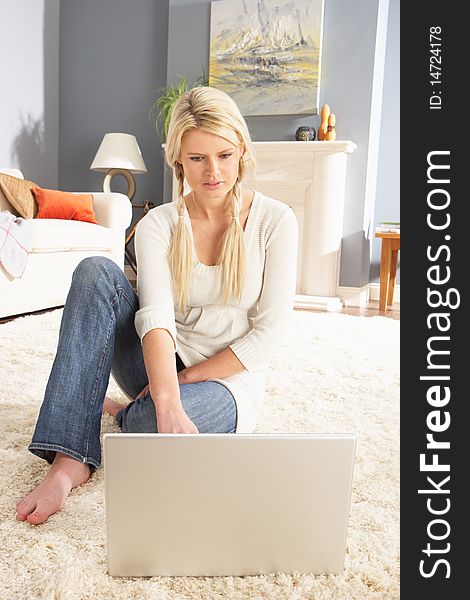 Woman Using Laptop To Manage Laying On Rug