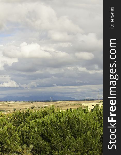 This image shows a landscape with a cloudy sky, threatening storm. This image shows a landscape with a cloudy sky, threatening storm
