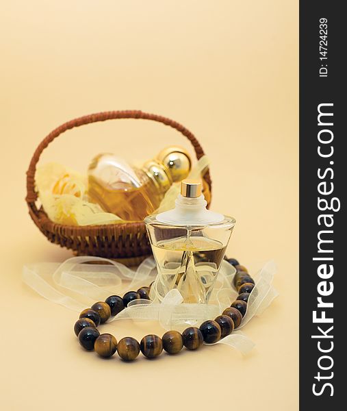 Perfumes and beads. Perfume in a basket