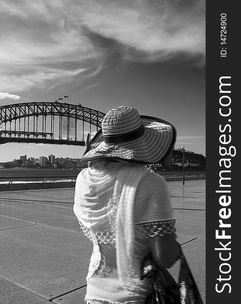 Tourist walking in front of Sydney Harbour Bridge. Tourist walking in front of Sydney Harbour Bridge