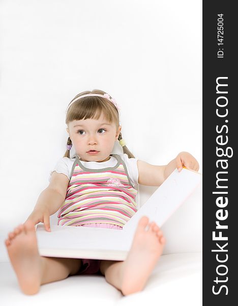 Sweet happy little girl reading book