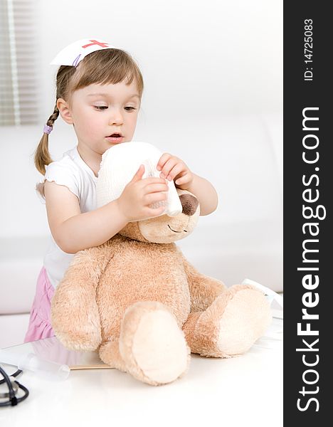 Sweet little girl doctor with teddy bear