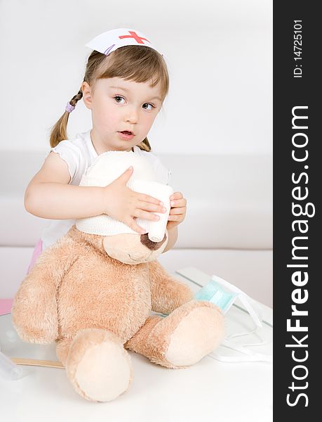 Little girl doctor with teddy bear