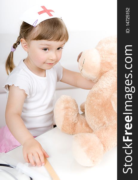 Little girl doctor with teddy bear