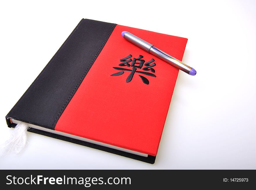 Oriental red and black diary with a pen