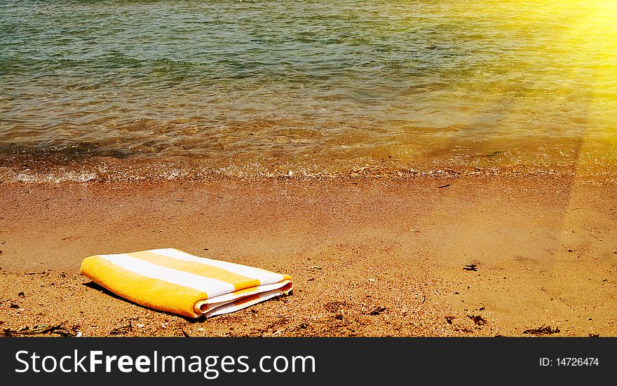 Sunbeams and beautiful towel next to the sea. Sunbeams and beautiful towel next to the sea.