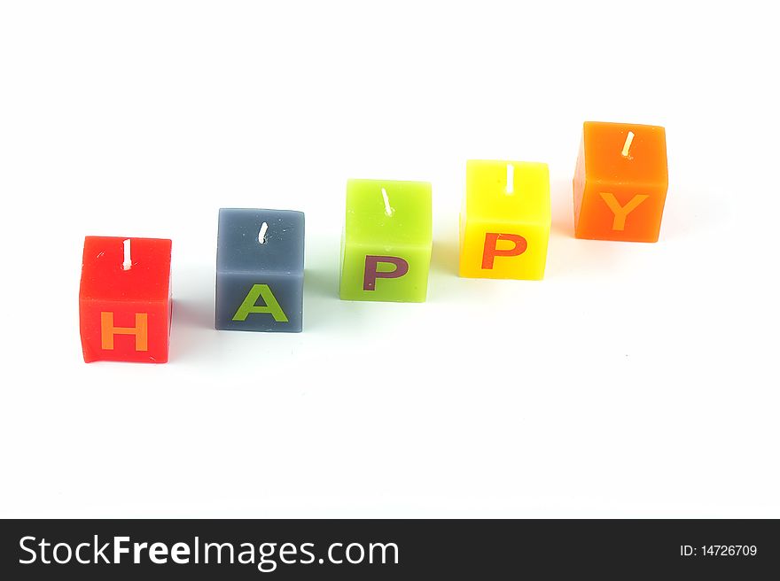 Colorful cubic candles with letters of the word Happy