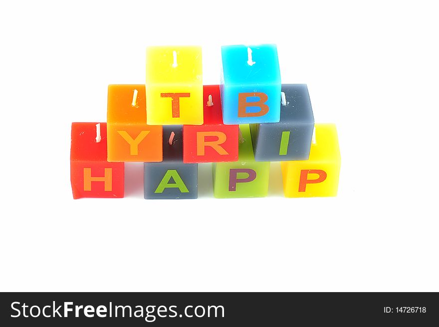 Colorful cubic candles with letters of the word Happy