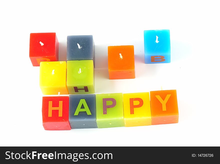 Colorful cubic candles with letters of the word Happy