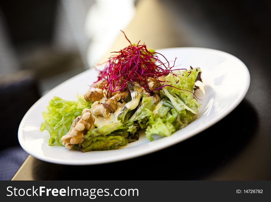 Beautiful, healthy mixed salad on a white plate. Beautiful, healthy mixed salad on a white plate