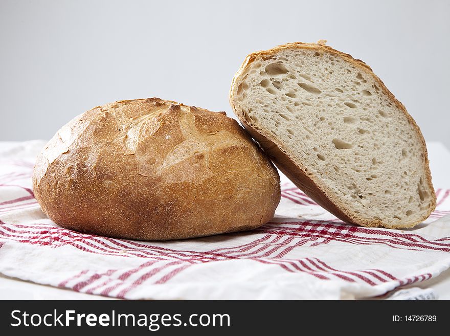 Fresh baked bread on a red and white cloth