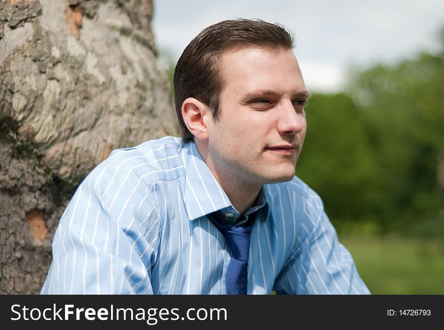 Happy young businessman relaxing in the sun. Happy young businessman relaxing in the sun