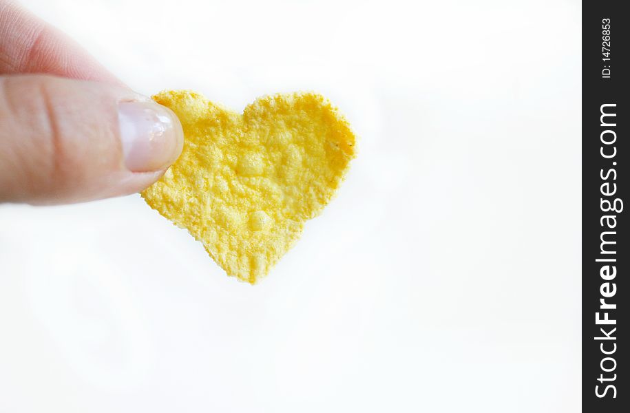 Cornflake like a heart in a woman hand. Cornflake like a heart in a woman hand