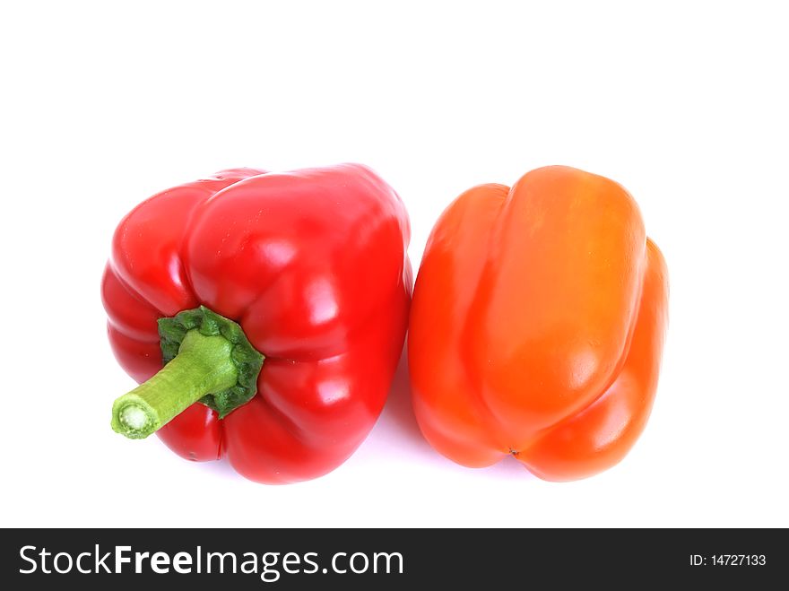 Red and orange pepper are on the white background