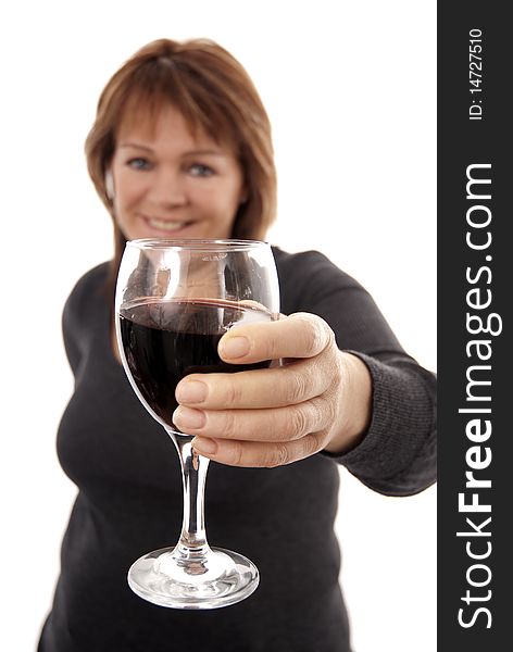 Woman holding glass of red wine to camera (focus on glass). Woman holding glass of red wine to camera (focus on glass)