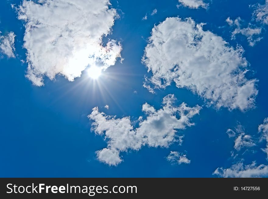 The sun sparkling behind clouds. The sun sparkling behind clouds
