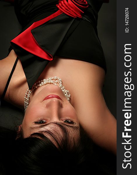 Sexy young woman lying on dark background. Sexy young woman lying on dark background