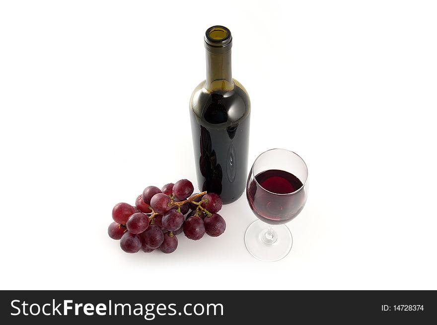 Wine bottle, red grapes and glass