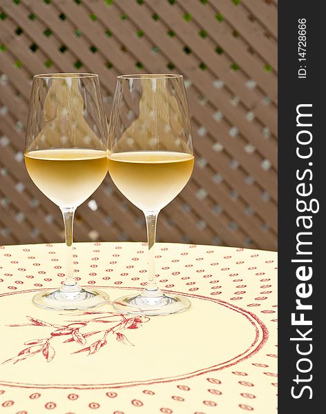 Two glasses of chilled white wine on a table. Two glasses of chilled white wine on a table.