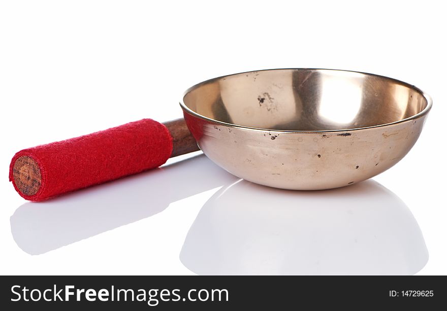 Tibetan singing bowl with mallet, a musical instrument used in Buddhist spiritual practice.