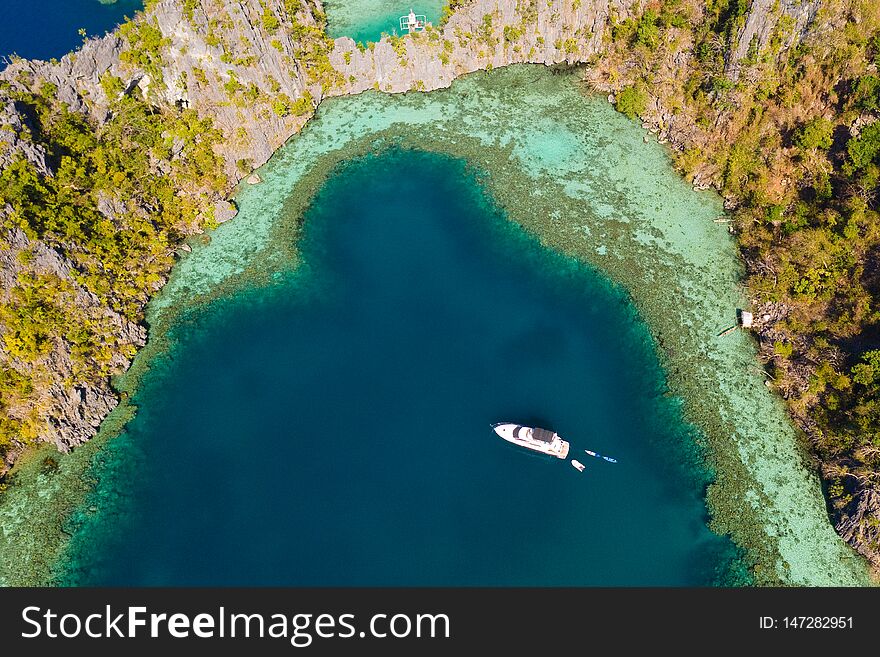 Boat in the azure lagoon.Lagoon with turquoise water surrounded by cliffs.